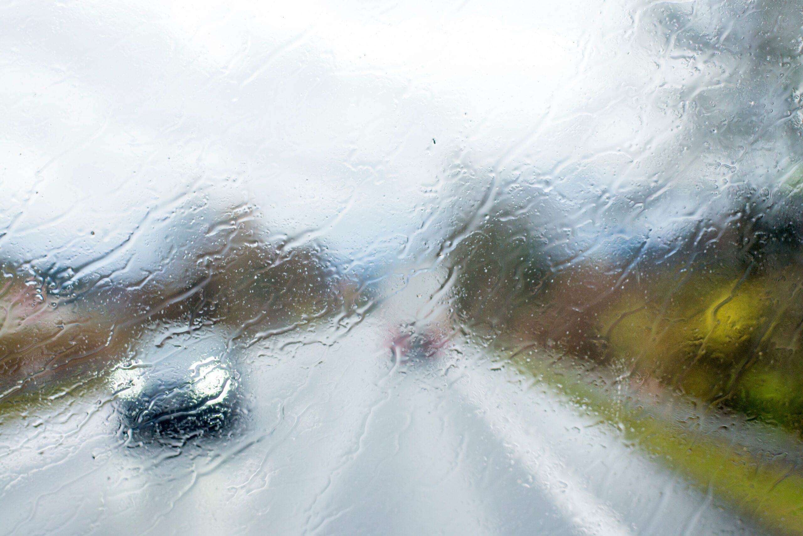 Windshield Covered in Frost and Rain on a Foggy Morning