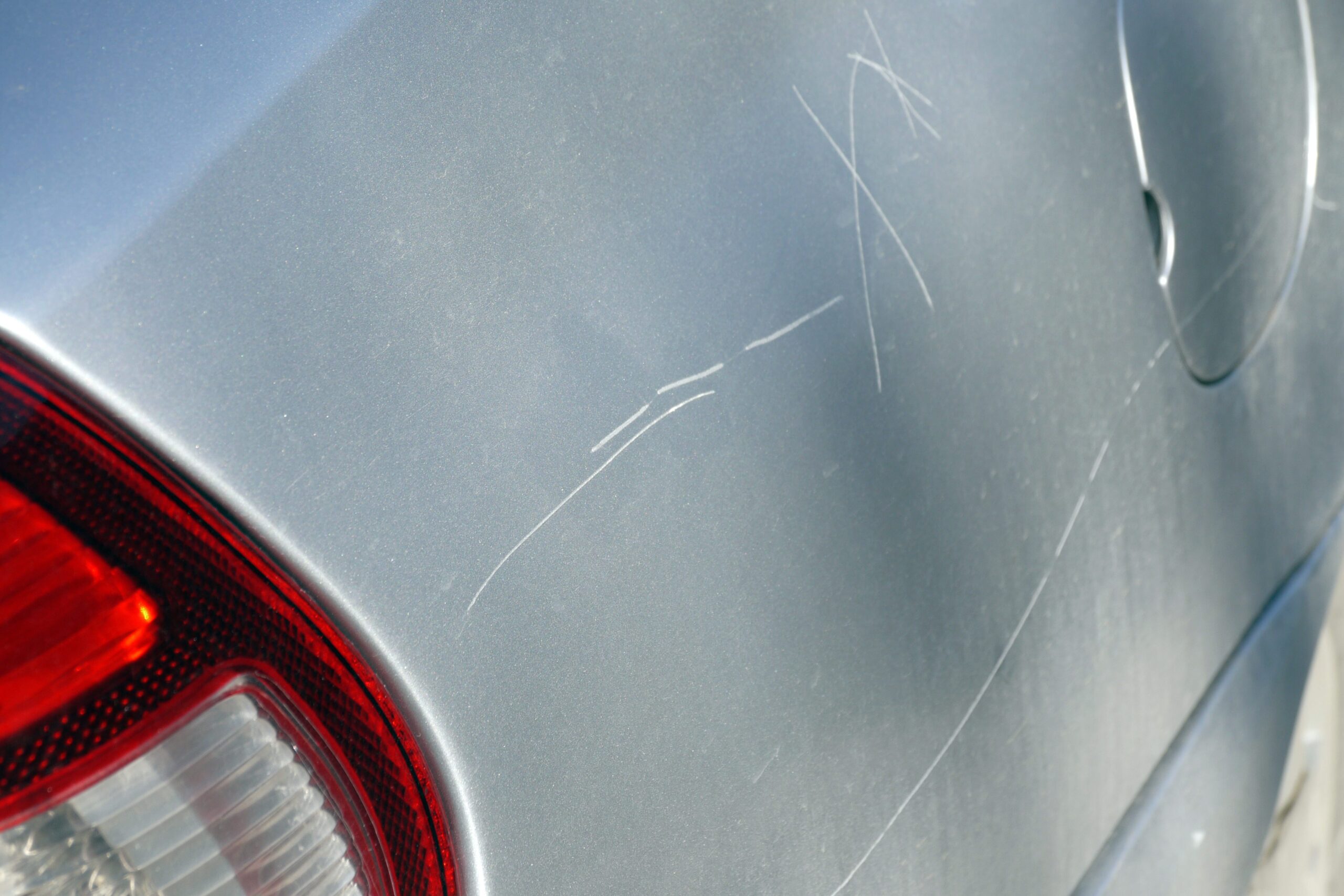 A scratched car in need of a scratch repair.