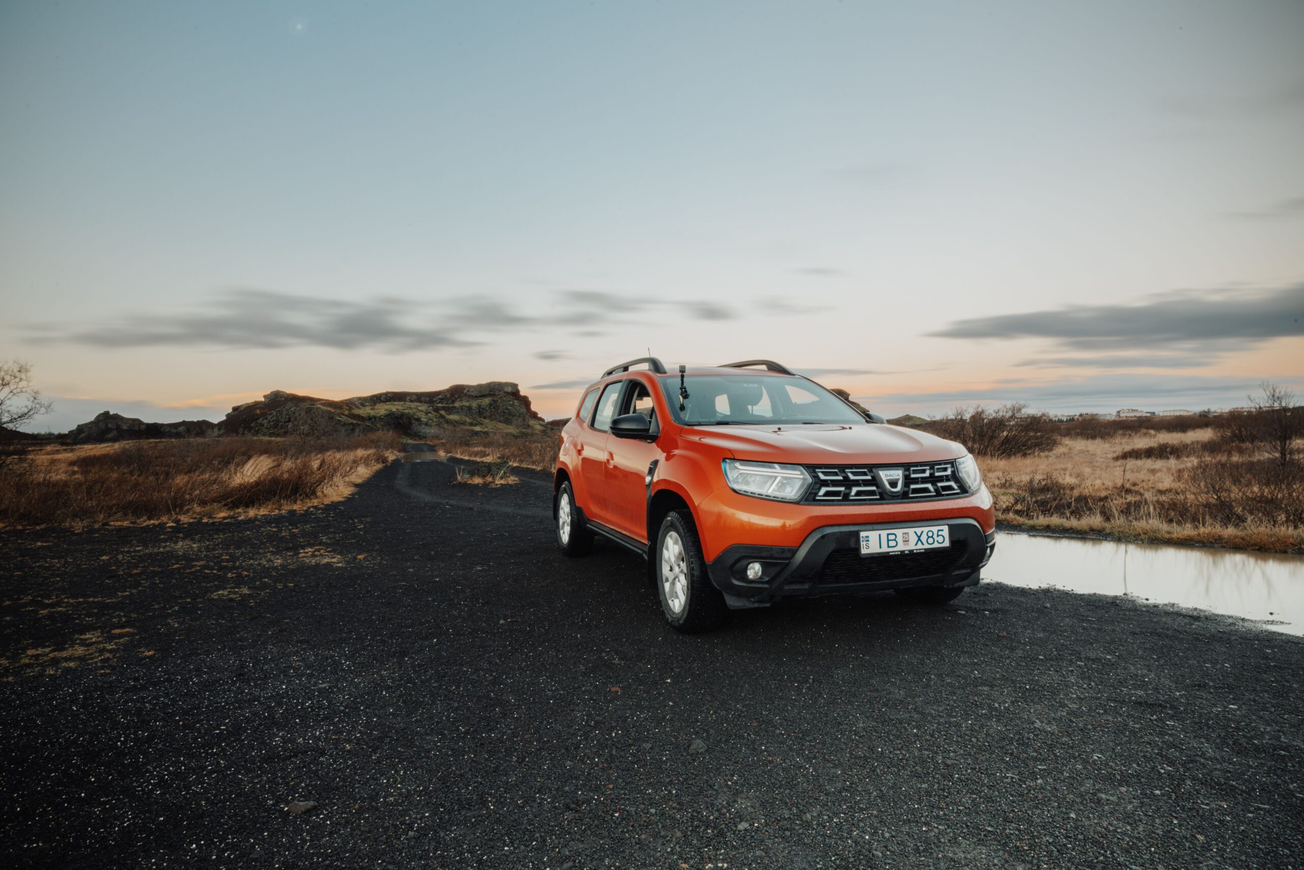 RedSUV parked on an open road at dusk after pre-trip automotive repair checks for a December road trip to the coast.